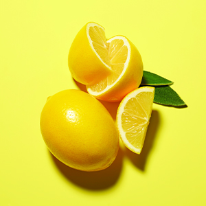 fresh cut lemons on a yellow background
